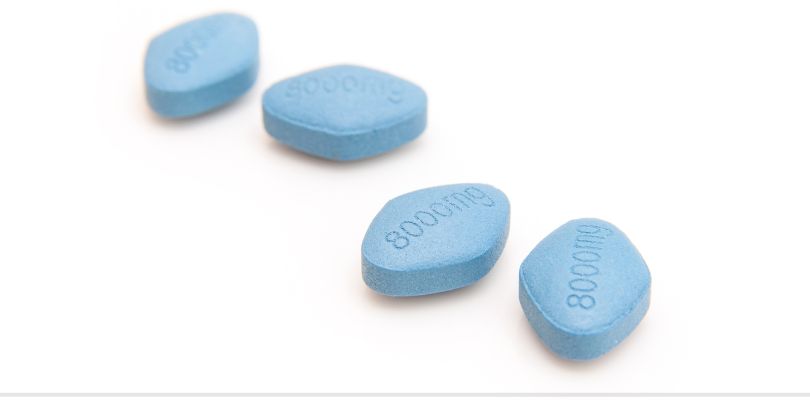 Four blue pills on a white background.